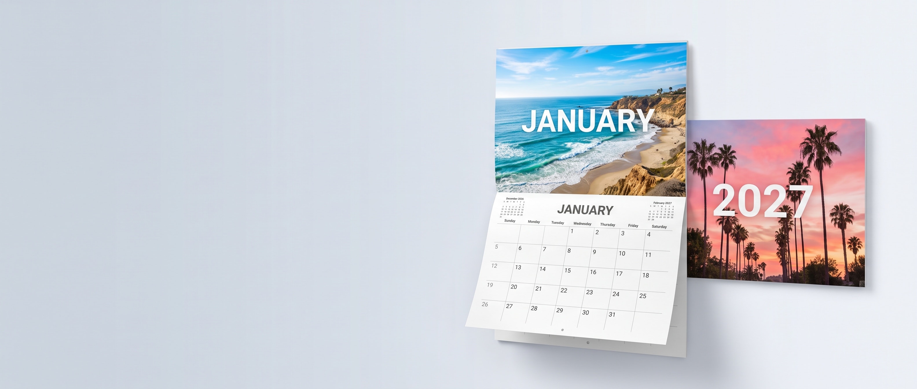 A custom wall calendar open to January beside a 2027 cover
